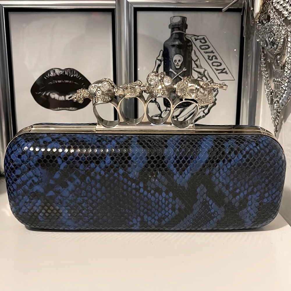 Blue snakeskin skull knuckle clutch bag